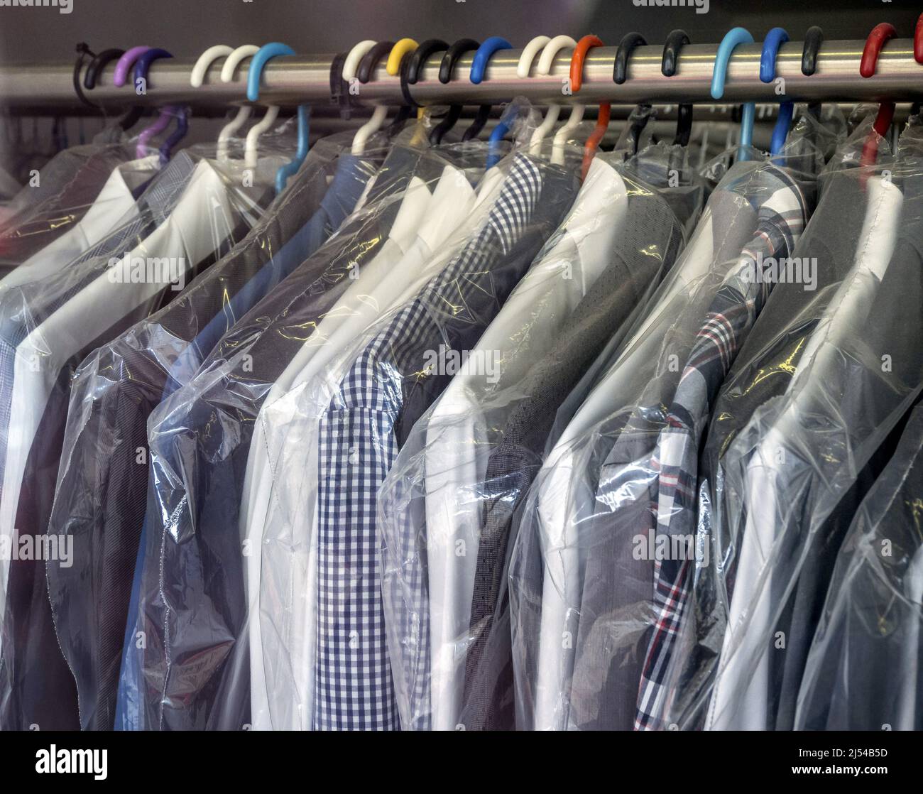 ready-to-collect, cleaned, plastic-wrapped shirts at a dry cleaner, Austria Stock Photo
