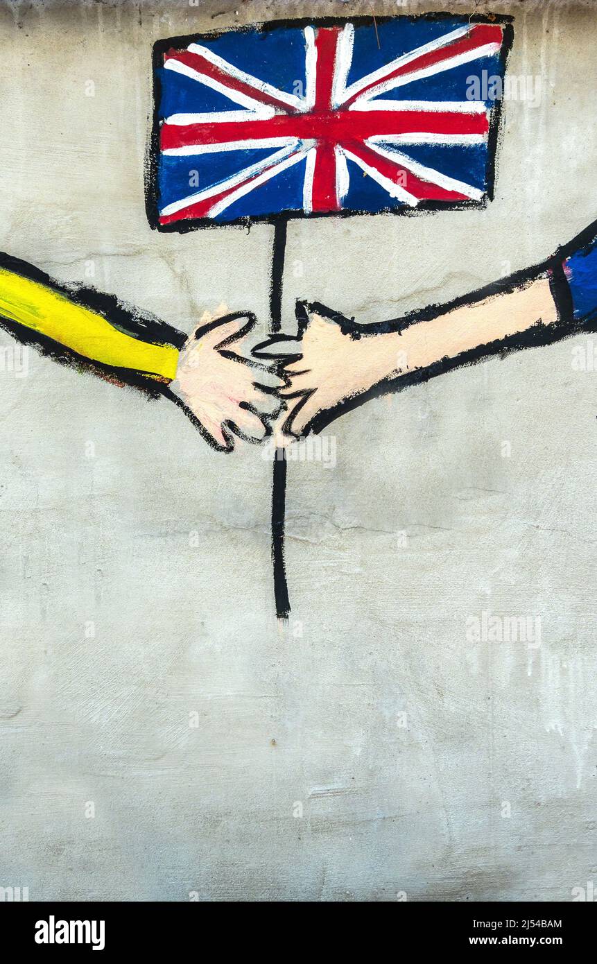 British flag with hands as graffiti on a brick wall Stock Photo