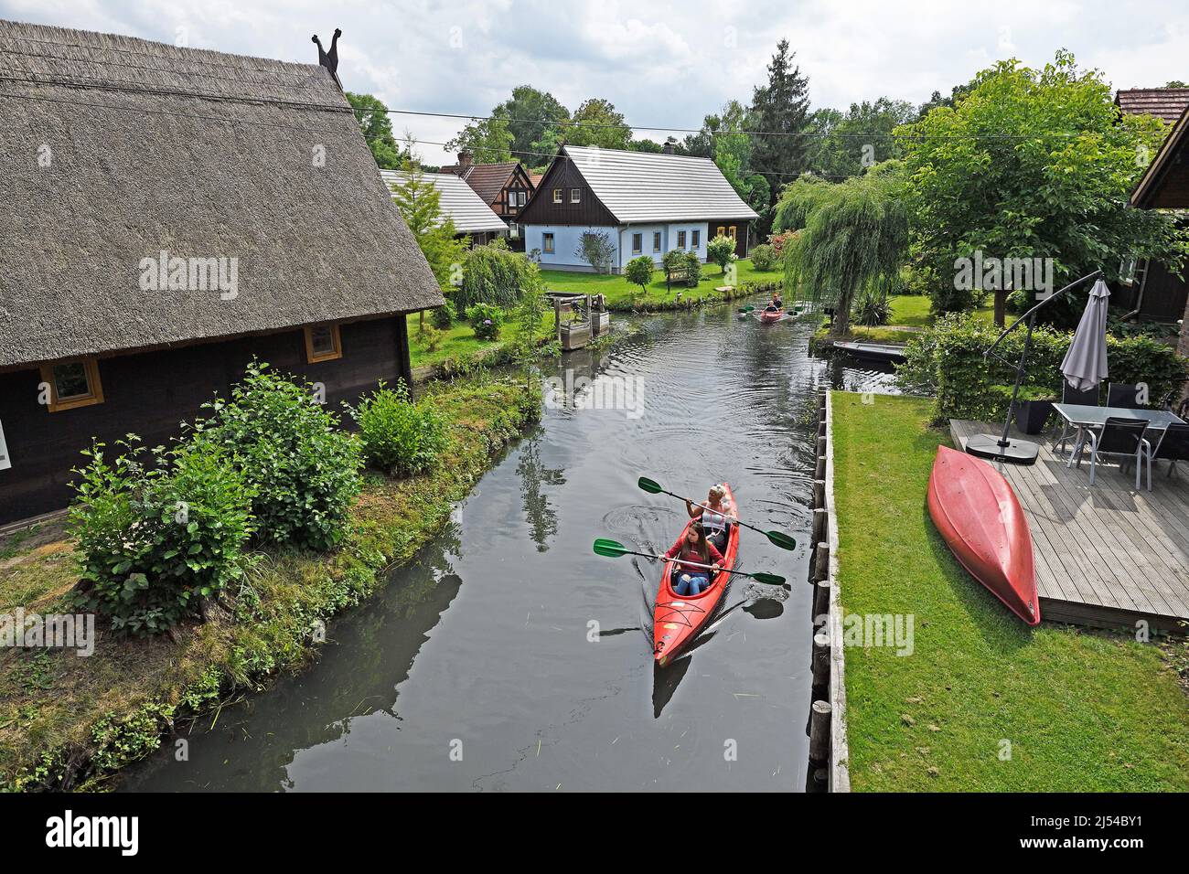 Tourists canoe through the village Lehde, Germany, Brandenburg Stock Photo