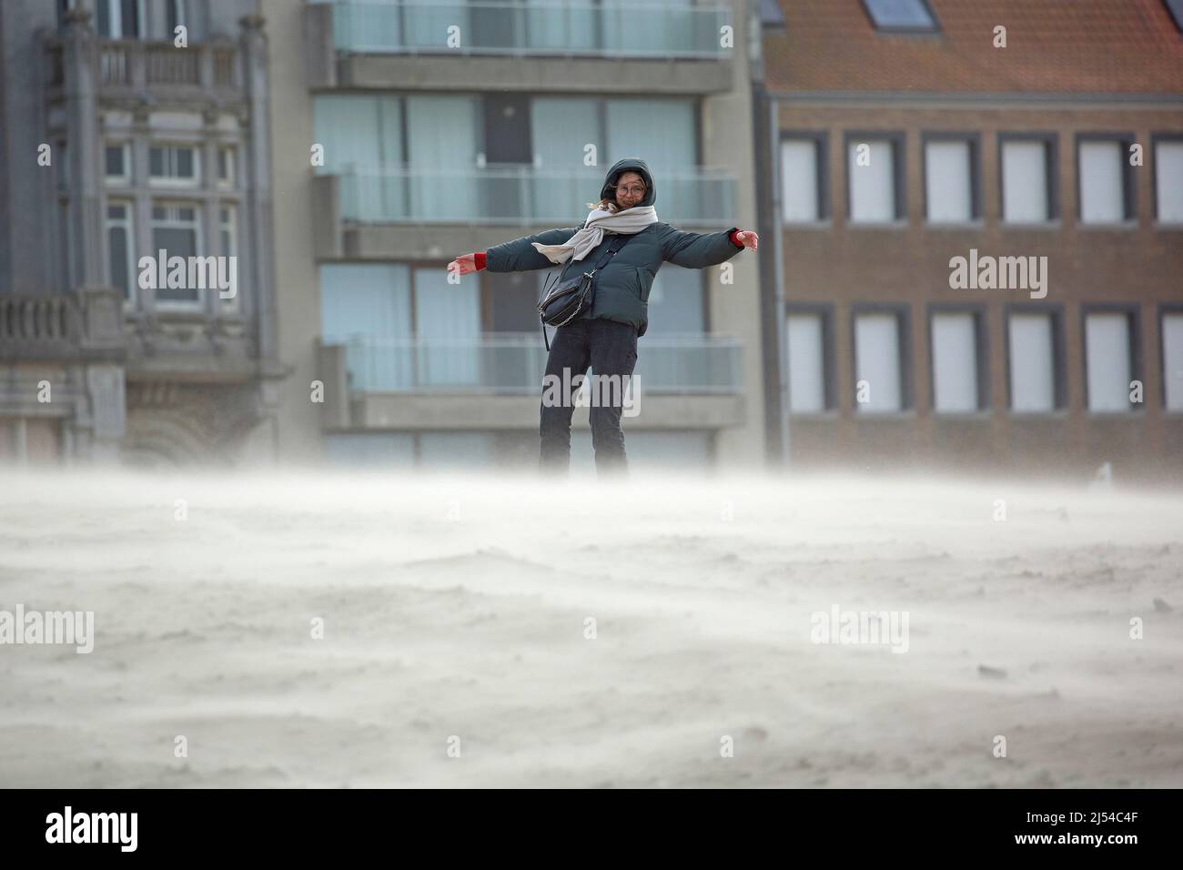 woman in the storm on the sandy beach, Hurricane Eunice, Zeynep, 02/18/2022, Belgium, West Flanders, Nieuwpoort Stock Photo