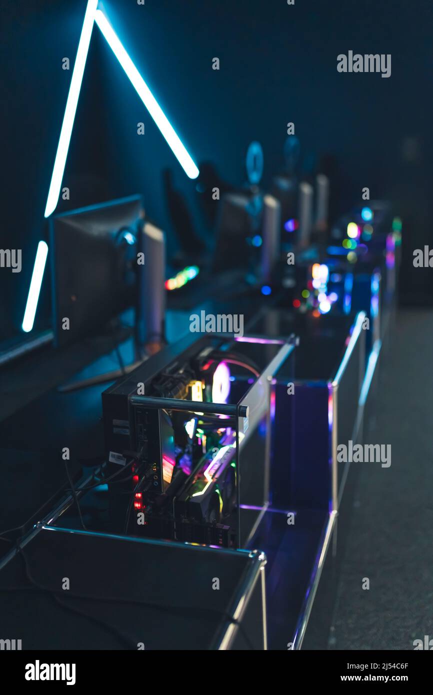 Vertical shot of illuminated cybercafe. Atmospheric interior. High quality computer equipment. Concept of modern internet activity. High quality photo Stock Photo