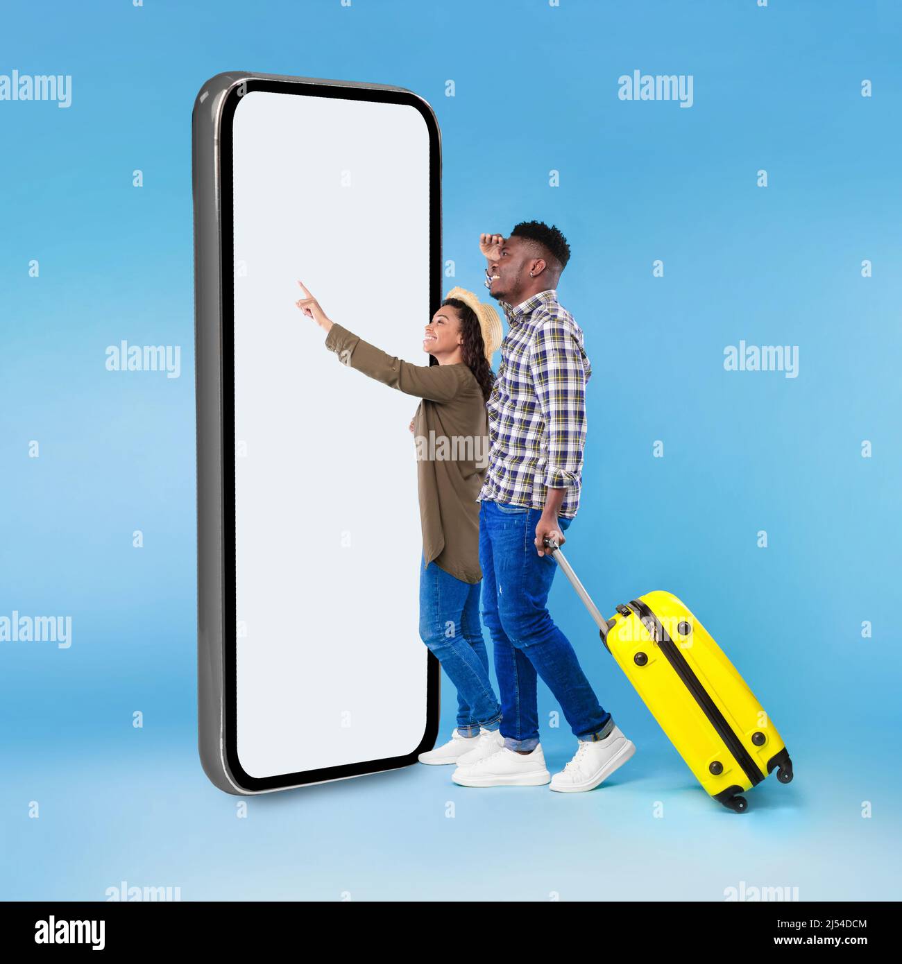 Black Tourists Couple Using Smartphone Touching Blank Screen, Blue Background Stock Photo