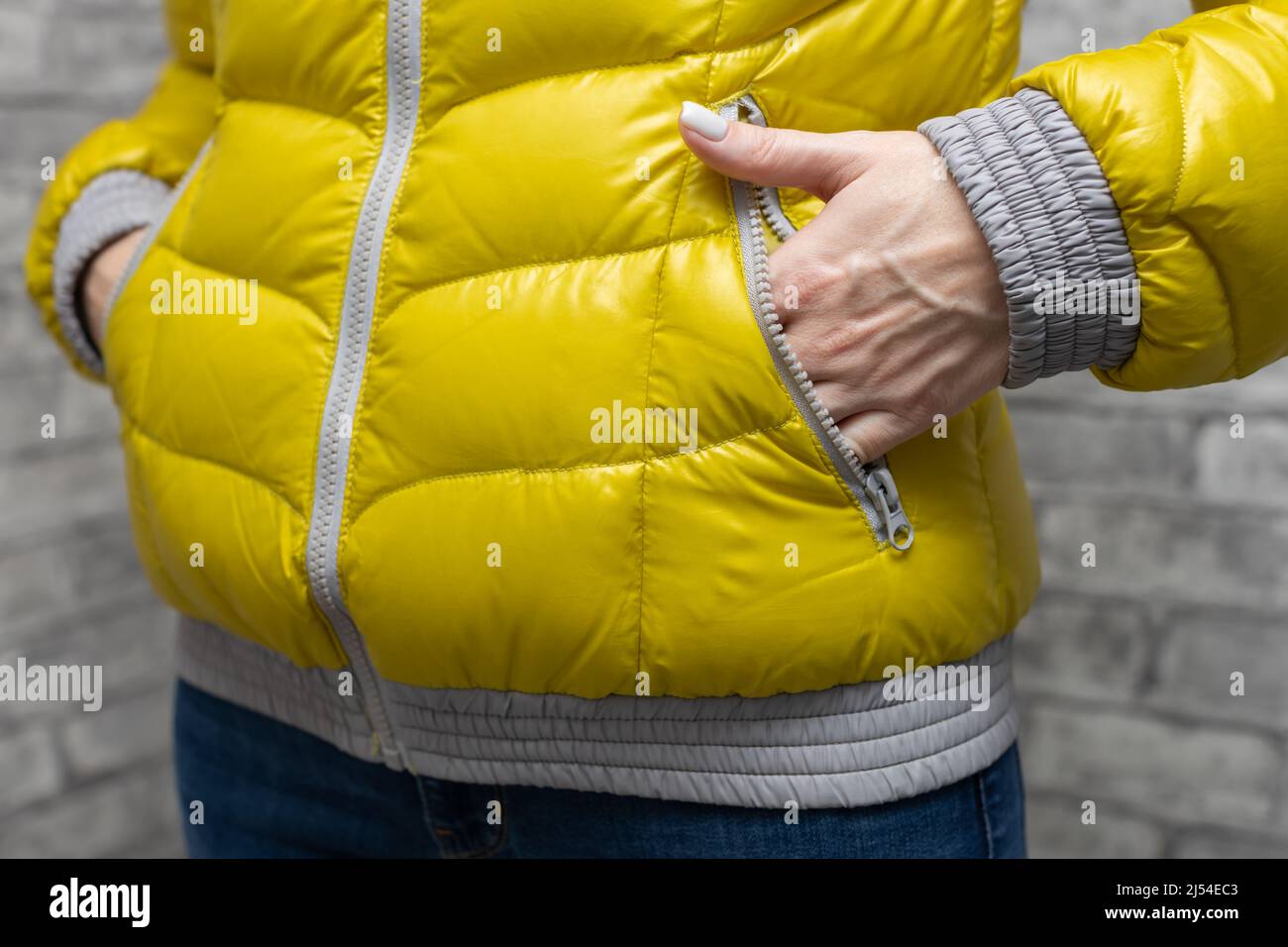 woman puts her hand in the pocket of a warm jacket. High quality photo Stock Photo