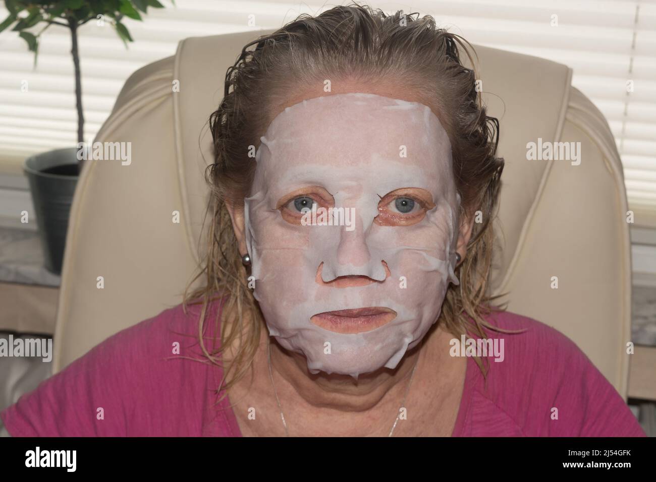 Spa therapy for woman getting facial mask in beauty salon Stock Photo