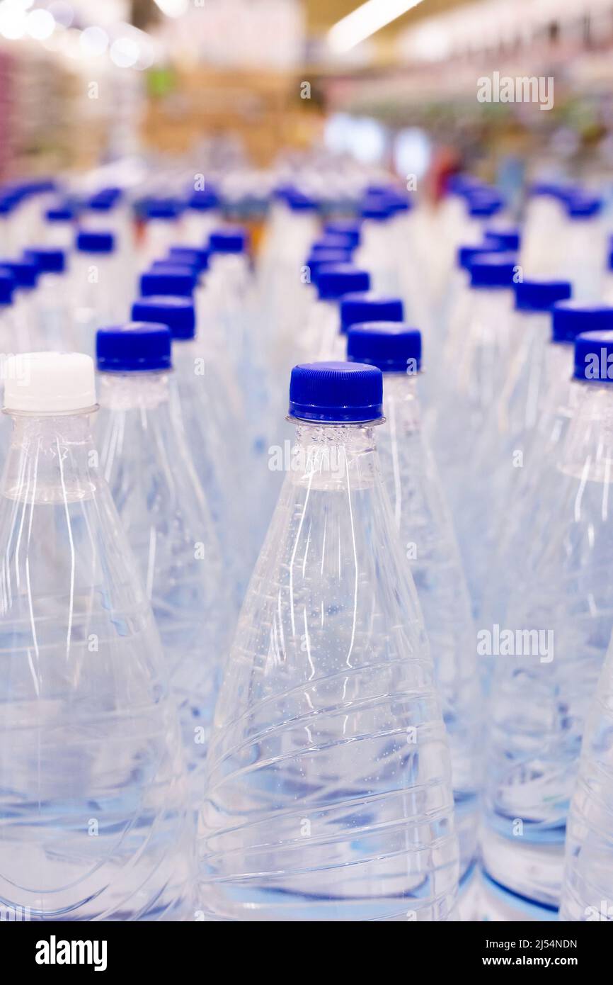 water bottles with blue caps in supermarket Stock Photo Alamy