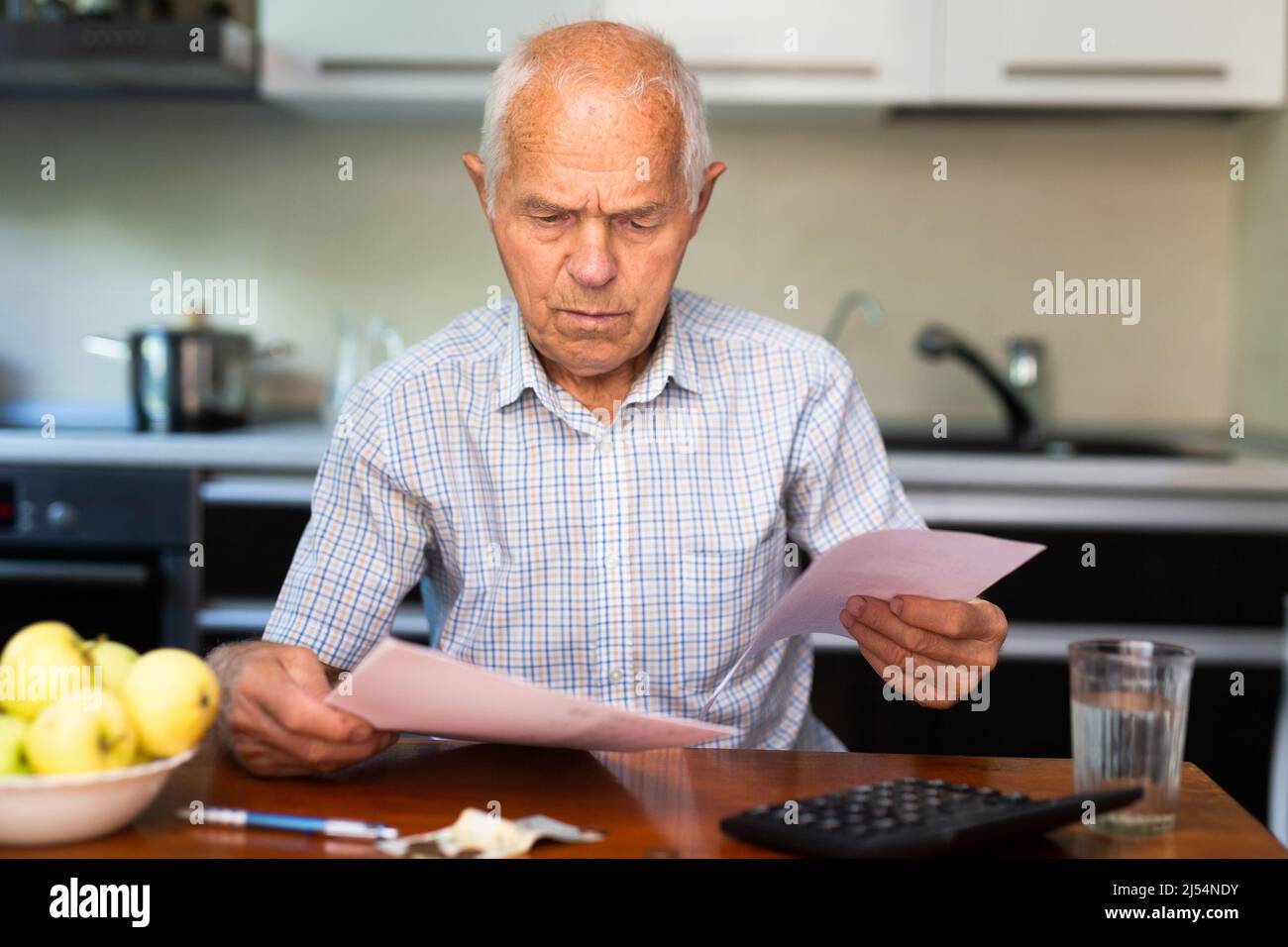Senior man and utility bills Stock Photo - Alamy
