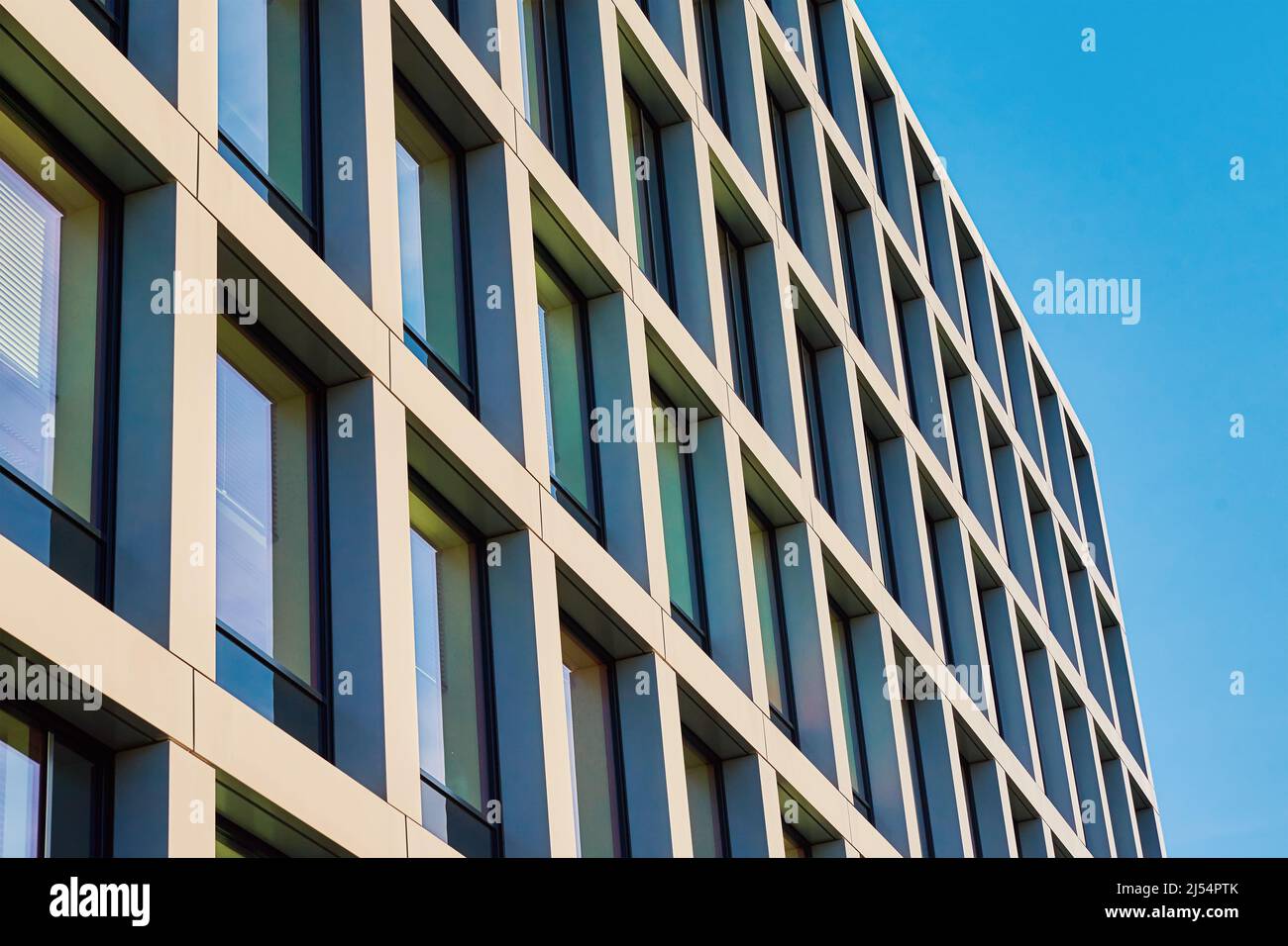 Modern building facade with windows against blue sky Stock Photo - Alamy