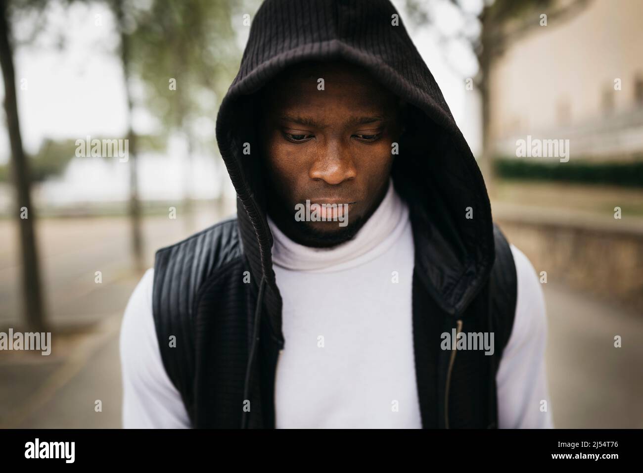 Portrait of a hooded young black male on the street Stock Photo