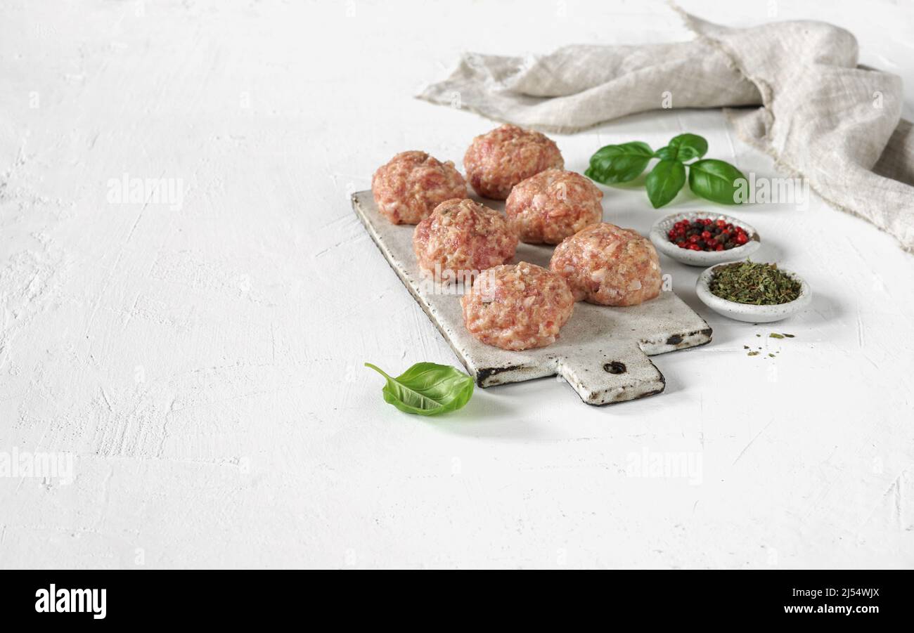 homemade meat ball with basil on the board on white background, copy ...