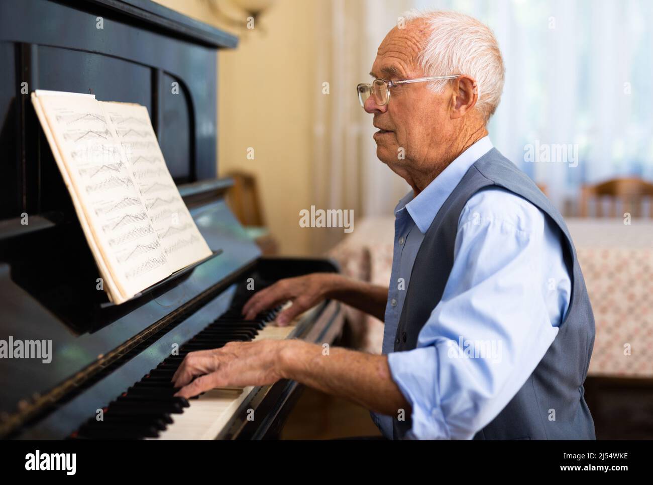 Compositor creating new music with piano at home Stock Photo - Alamy
