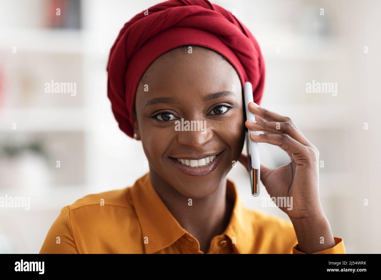 Closeup portrait of pretty black woman talking on phone Stock Photo