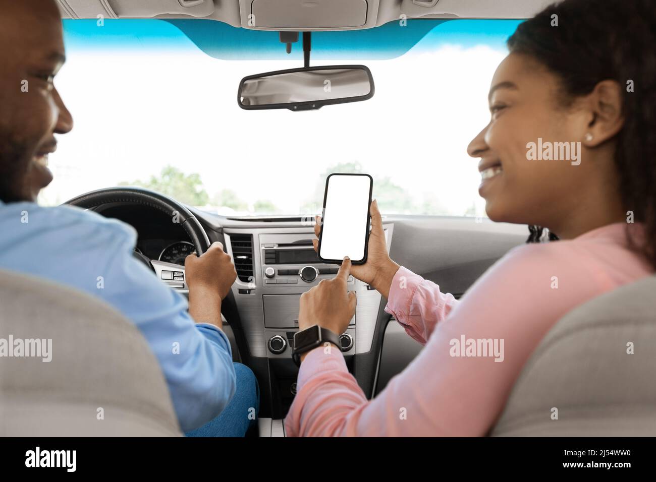 Happy African couple using showing smartphone with empty screen Stock Photo