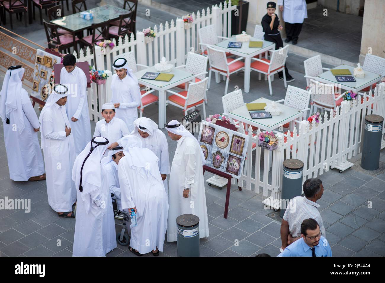 Doha,Qatar, April 15,,2022, Local people at auction of antiques on the passage of the old market market souk Waqif. Stock Photo