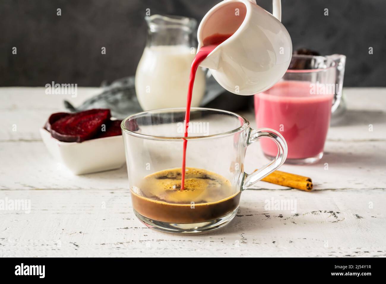 Espresso with beetroot latte pouring to cup and basic ingredients.  Stock Photo