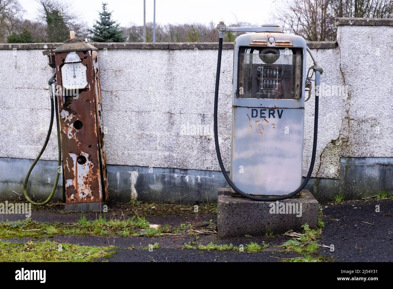 Rusting and disused petrol pumps at old service station in Northern Ireland. Stock Photo
