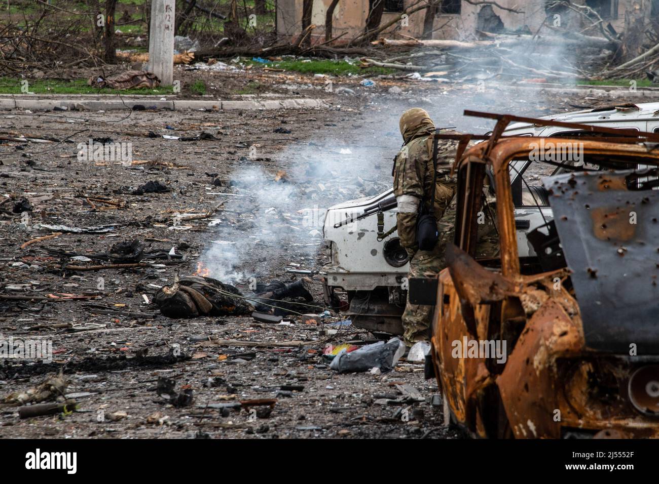 Mariupol, Ukraine. 18Th Apr, 2022. (Editors Note Image Depicts Death) A  Russian Soldier Stands Near The Burning Body Of A Tank Crew Member Killed  In Fighting Earlier Around The Azovstal Plant In