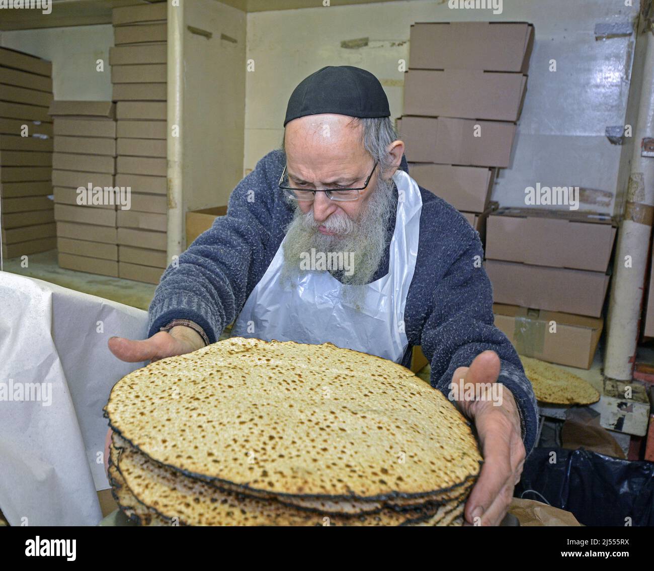 A rabbi packages shmura matzoh to be used on Passover. At a Lubavitch