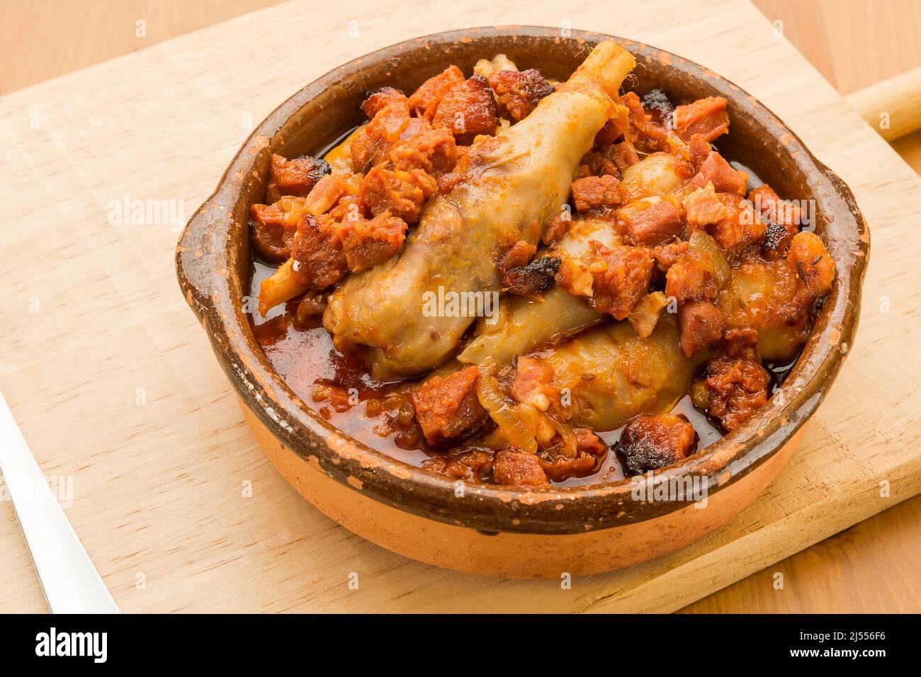 Typical Spanish food, lamb trotters with ham and chorizo. Stock Photo