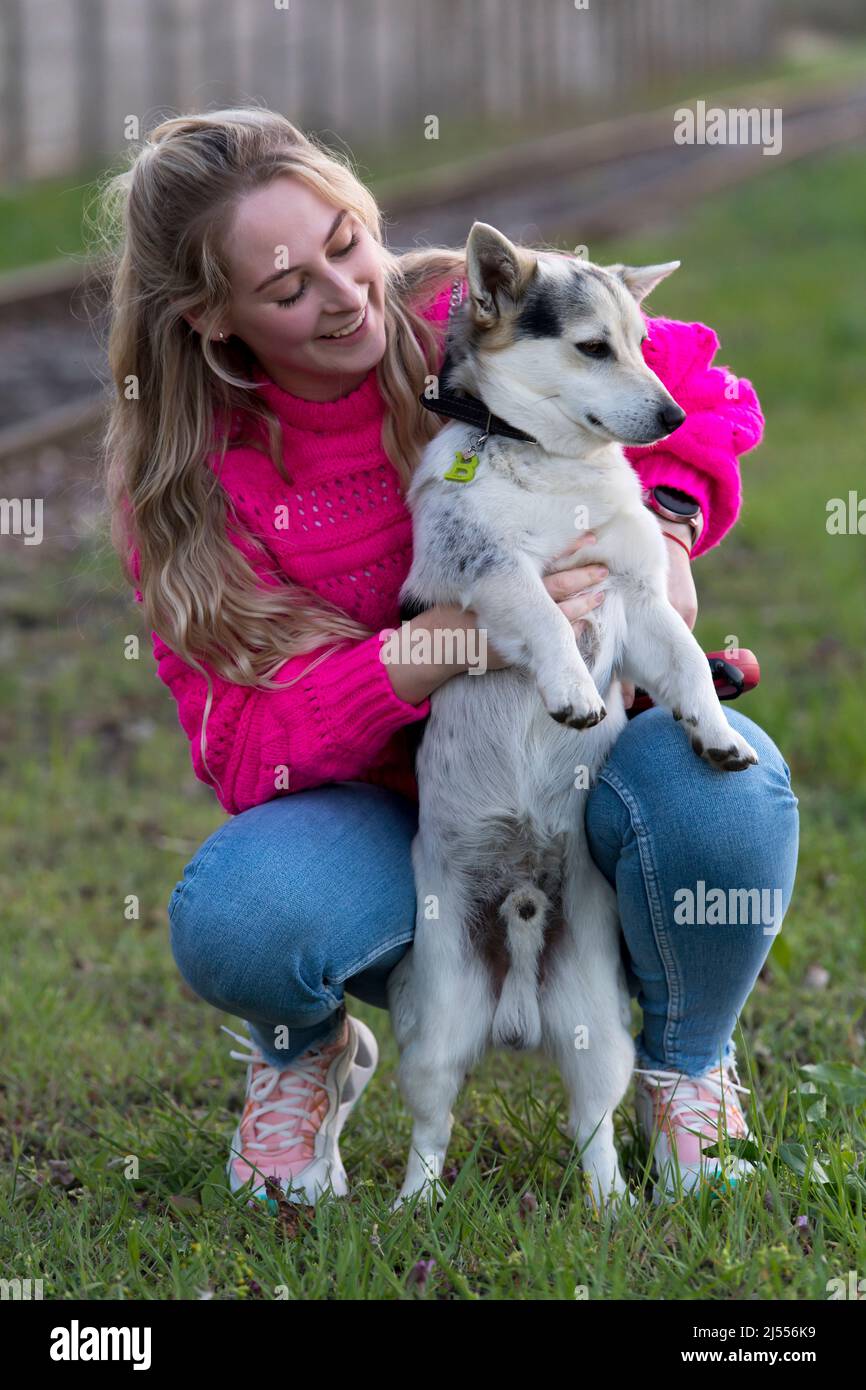 blond cute girl with her dog outdoor Stock Photo