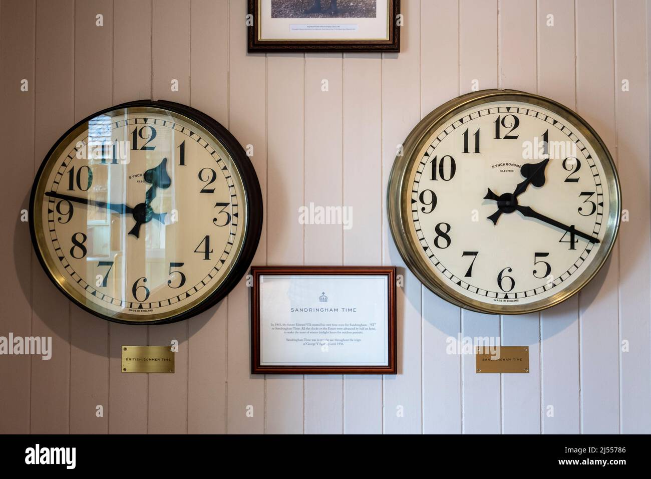 Two clocks on the Royal Estate at Sandringham show the difference between GMT and Sandringham Time.  See Details in Description. Stock Photo