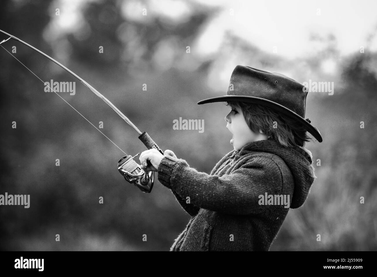 Kid fishing with spinning reel. Kids fly fishing Stock Photo - Alamy