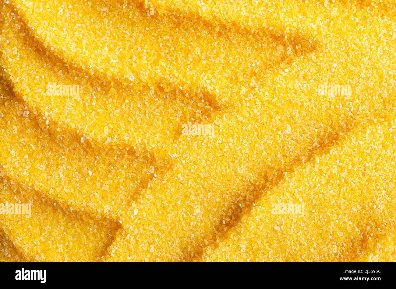Abstract background of uncooked cornmeal. Stock Photo