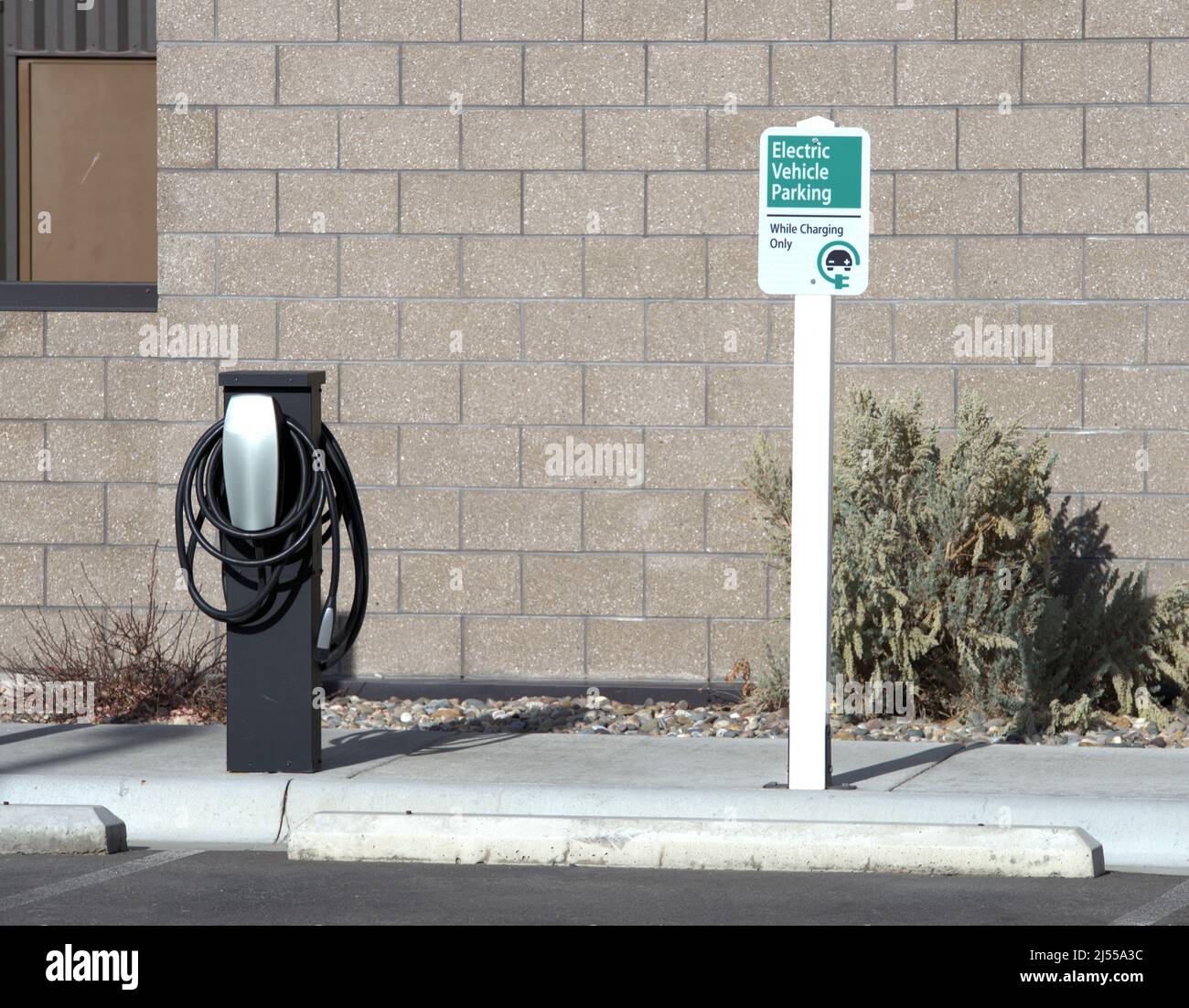 EV Charging station with limited parking sign Stock Photo
