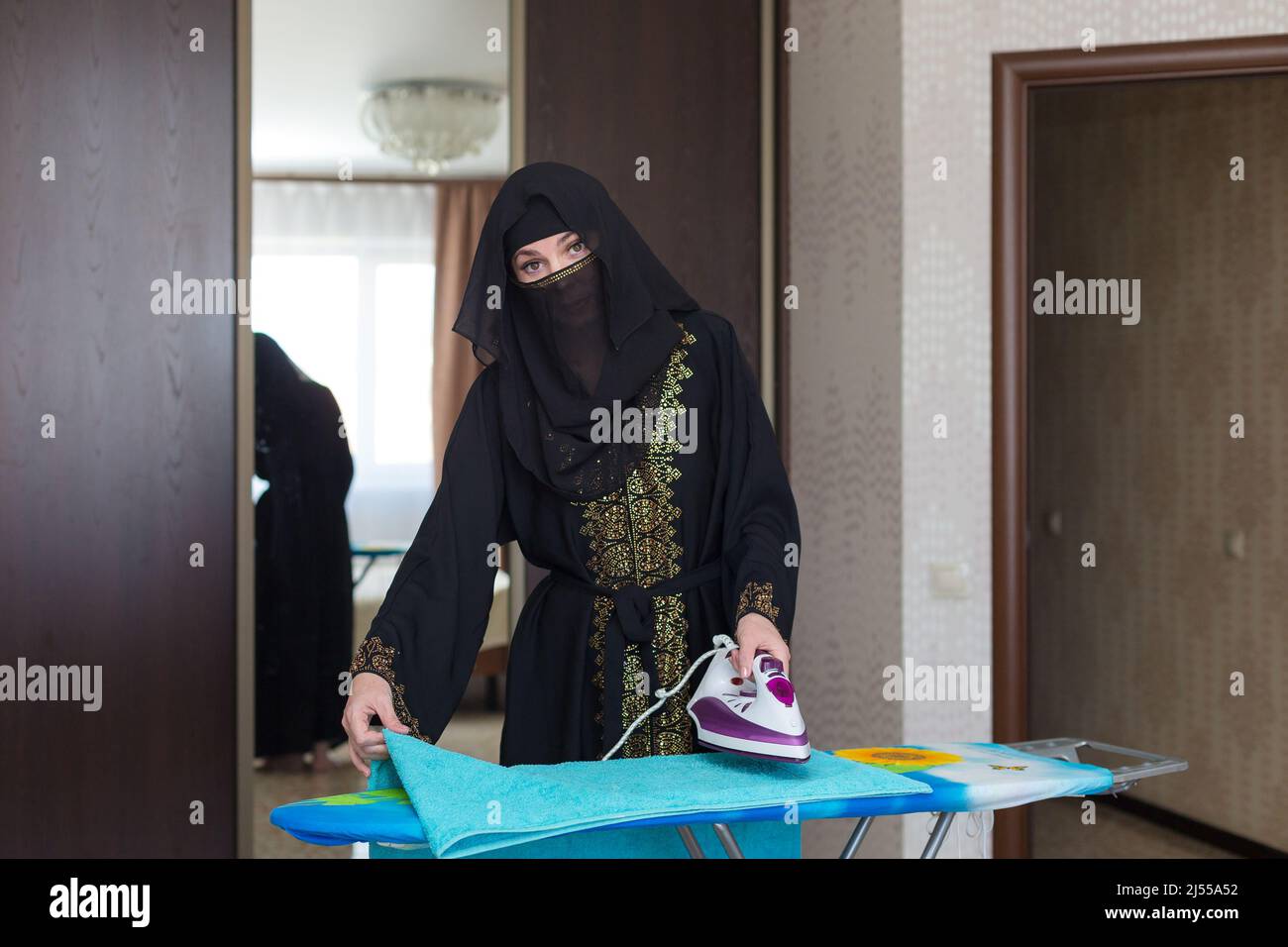 Muslim woman doing household chores, ironing things Stock Photo Alamy