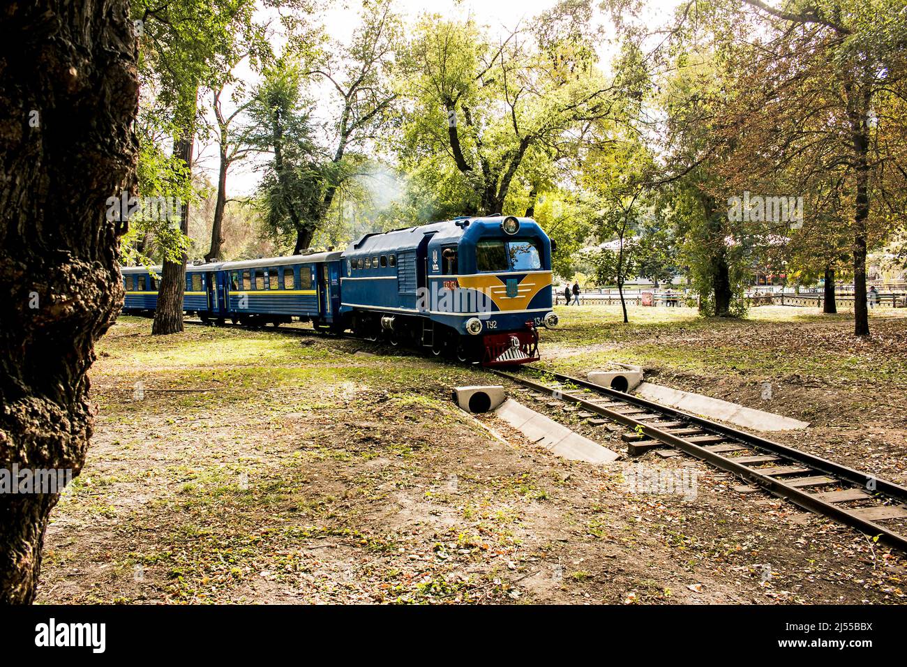 Dnepropetrovsk, Ukraine - 10.03.2021: Ukrainian children's railway in the city park. The movement of the locomotive. Traffic fumes. Stock Photo