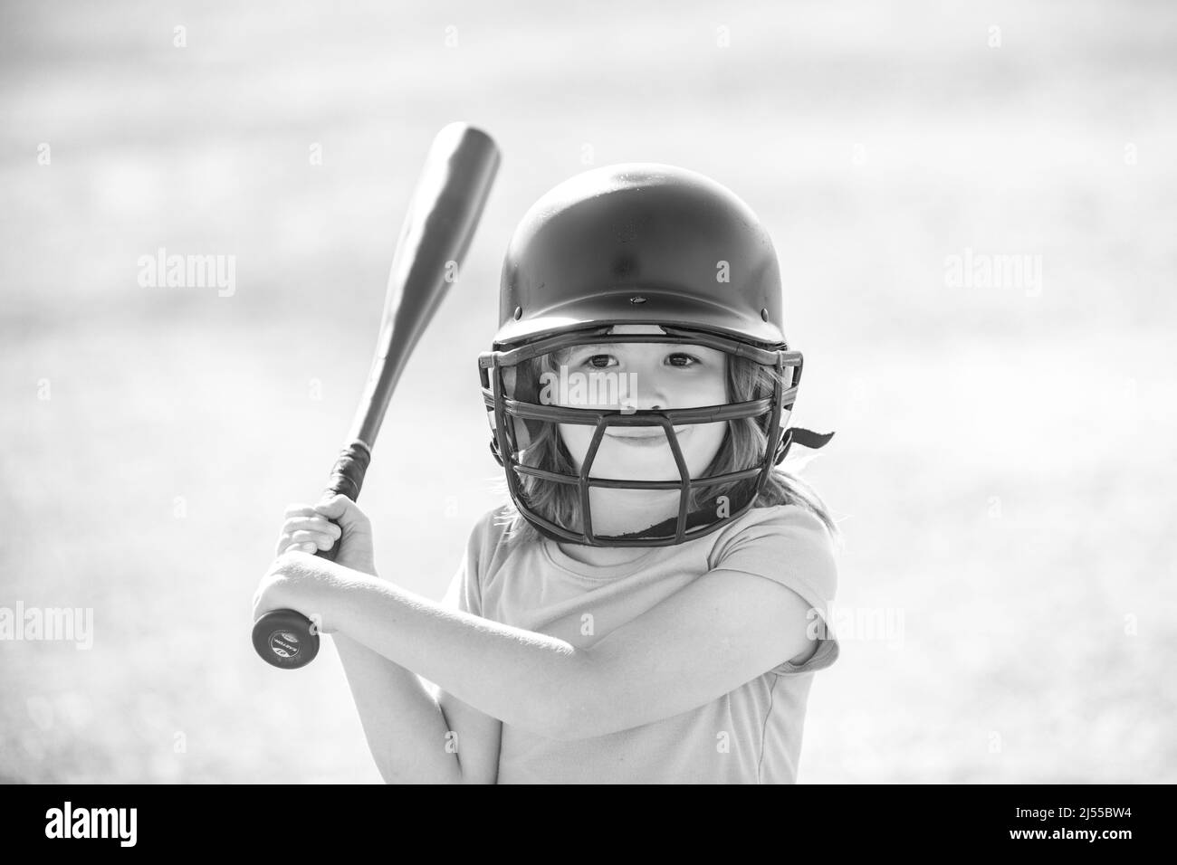 Little child baseball player focused ready to bat. Kid holding a