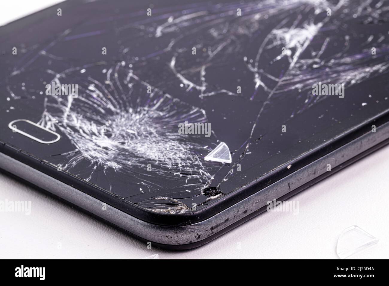 smartphone broken in fall, screen and protective film cracked, has repair. Stock Photo