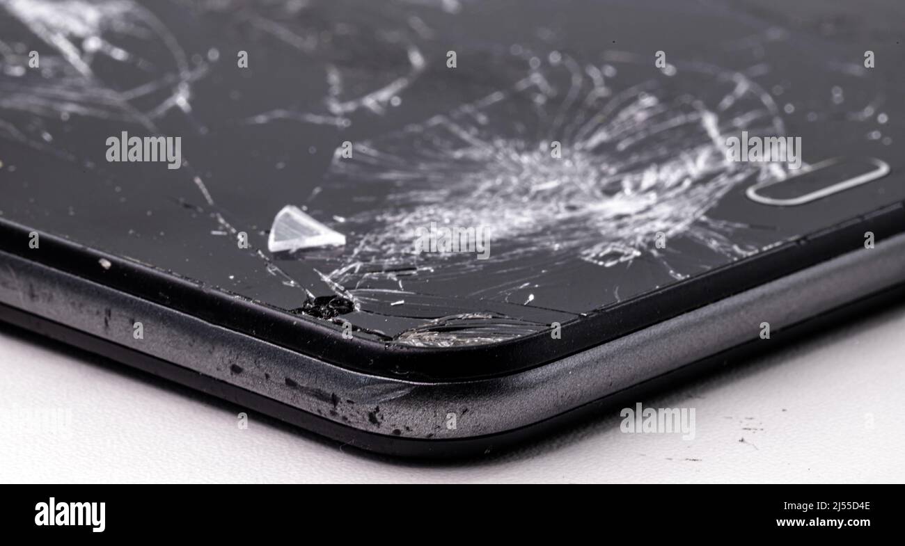 smartphone broken in fall, screen and protective film cracked, has repair. Stock Photo