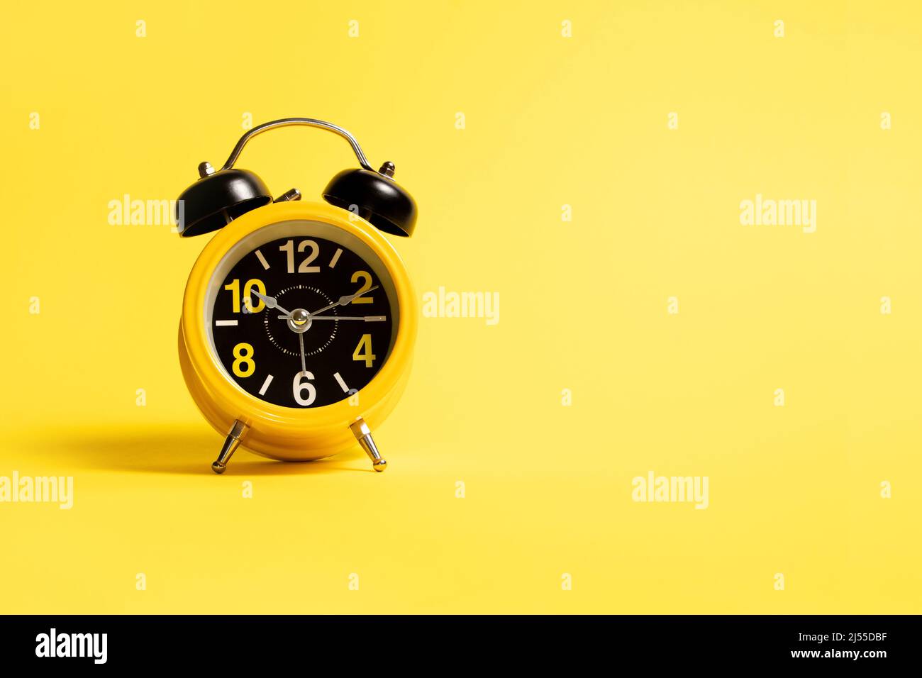 Yellow alarm clock on a yellow background Stock Photo Alamy