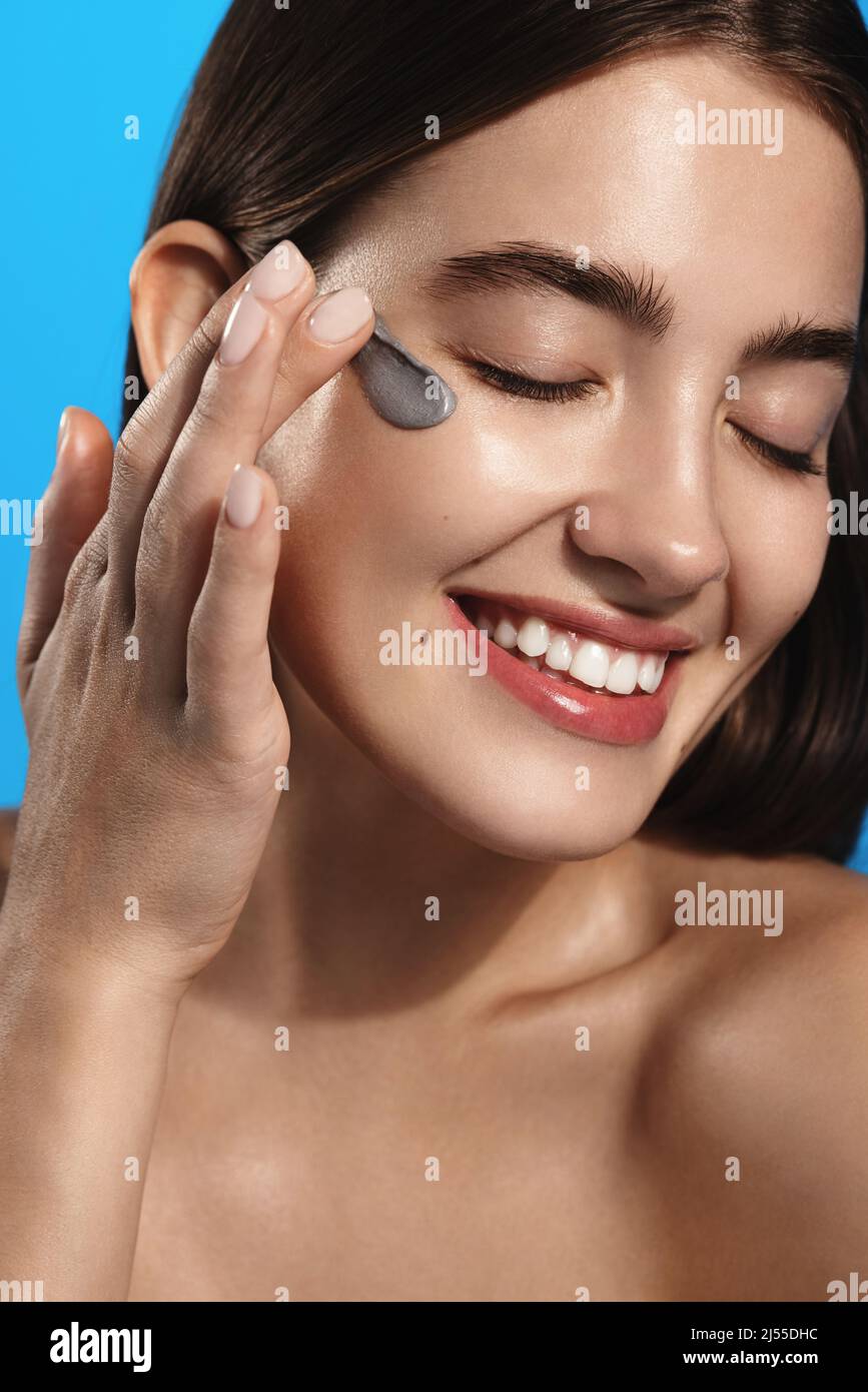 Beauty woman applying face cream on clean fresh skin, detoxifying effect, moisturize and hydrate