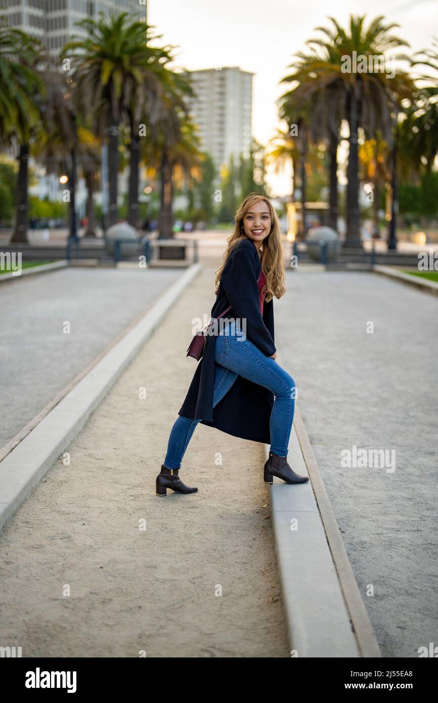 Young Woman in Casual Fall Wardrobe on Outdoor Bocce Ball Court in San