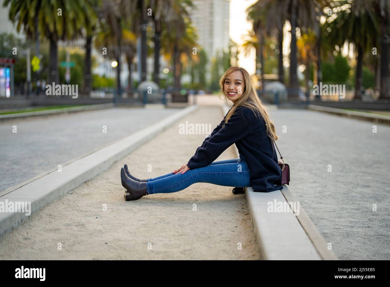 Young Woman in Casual Fall Wardrobe on Outdoor Bocce Ball Court in San