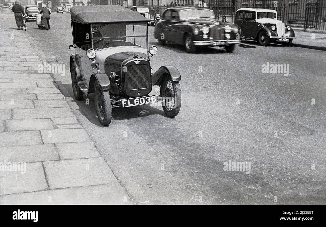 1960, historical, a 1920s Austin 7 car - also known as an Austin Chummy - parked on the street in Endsleigh Gardens, Bloomsbury, London, England, UK. The street, originally the south side of Euston Square was remamed in 1879.  Produced in the UK from 1922-1939, the Austin 7 was a small car, a 'Baby Austin' with restricted space at the back and so any occupants would be very close together, hence 'chummy'. Stock Photo