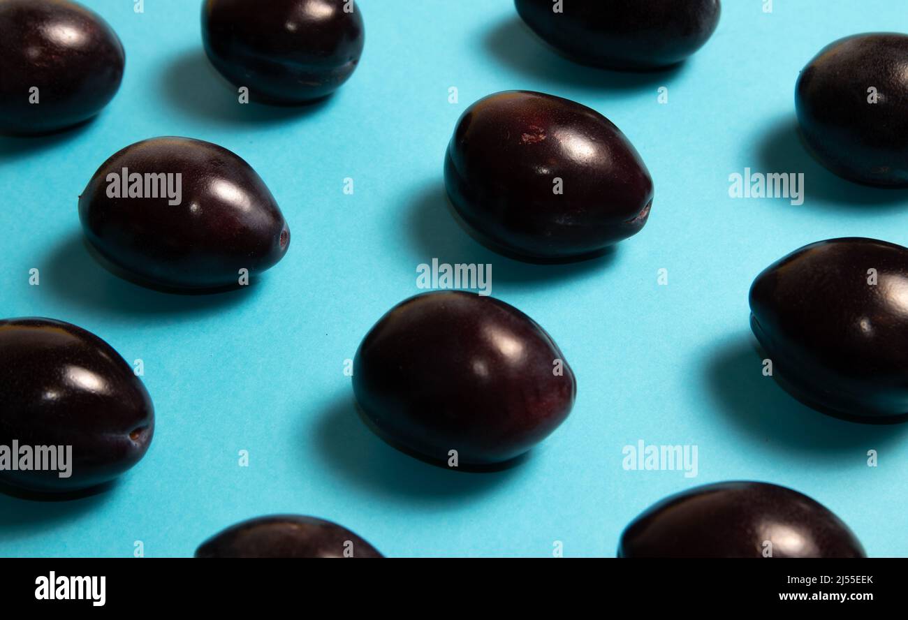 Fresh plums on blue background Stock Photo