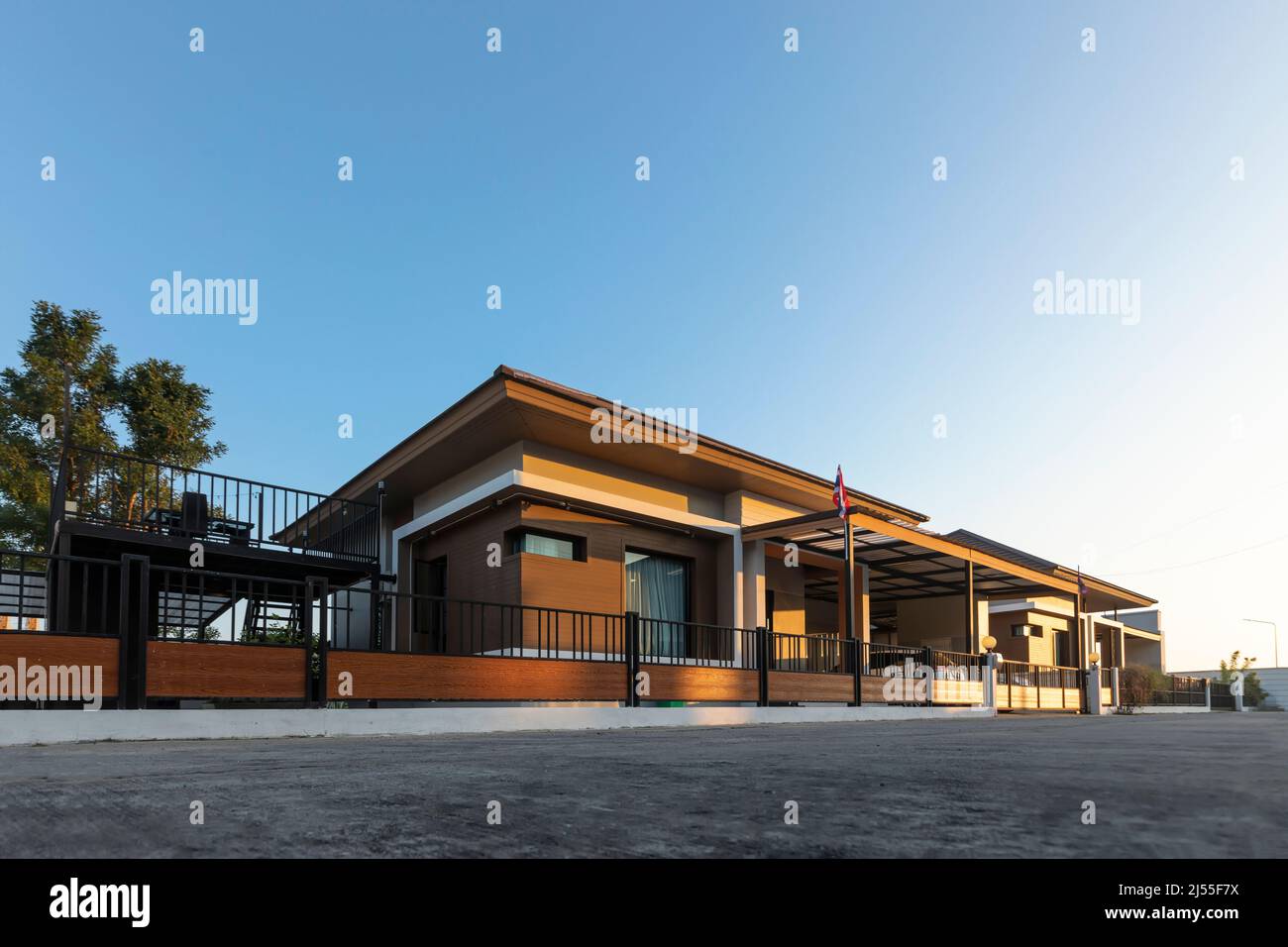 Outside view of the house with green fields against clear blue sky