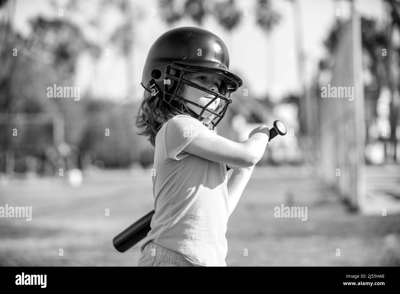 Boy kid holding a baseball bat. Pitcher child about to throw in youth