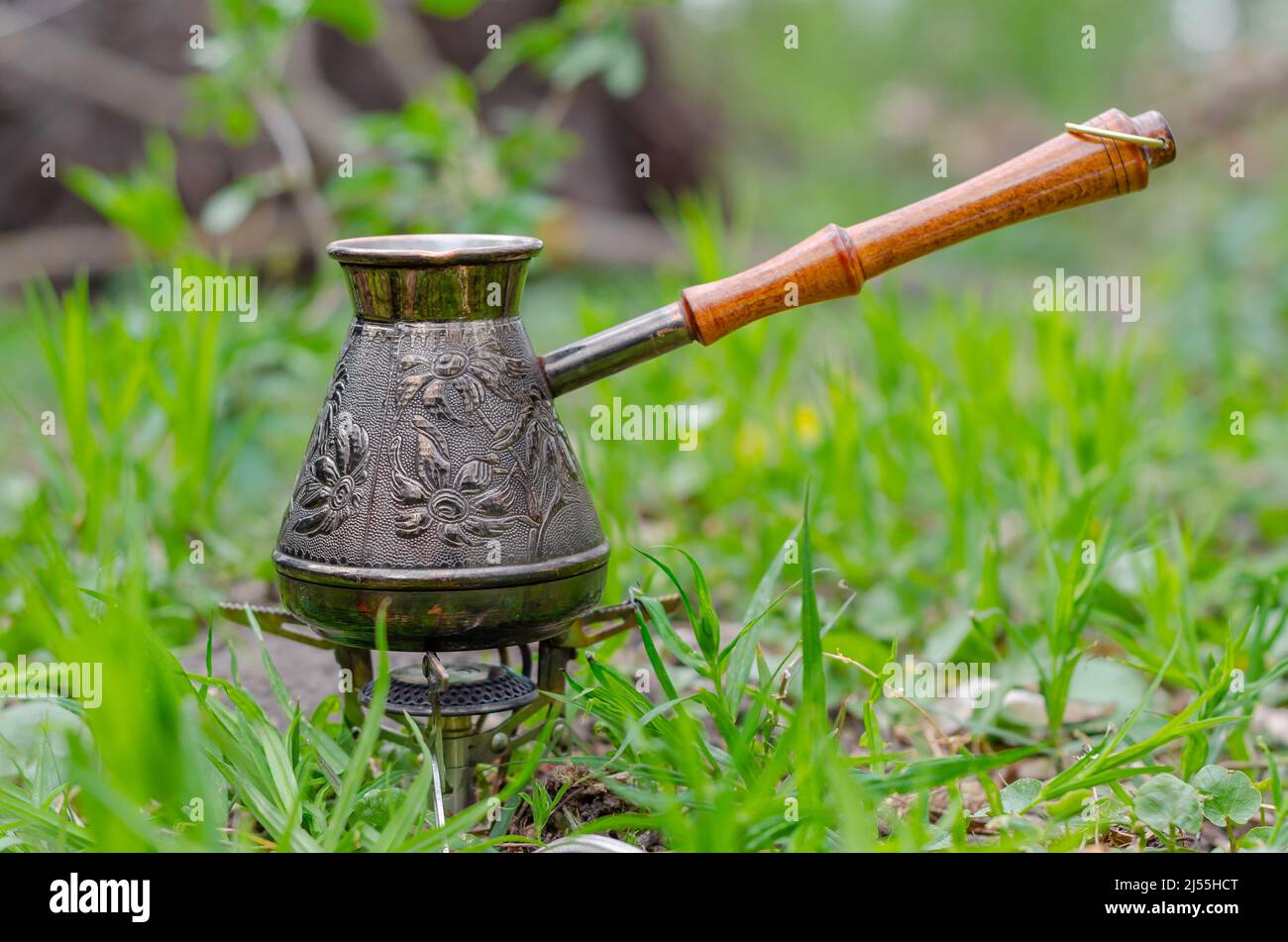 Turkish coffee on vacation in nature. Copper metal coffee maker on tourist gas burner. Delicious coffee. Stock Photo