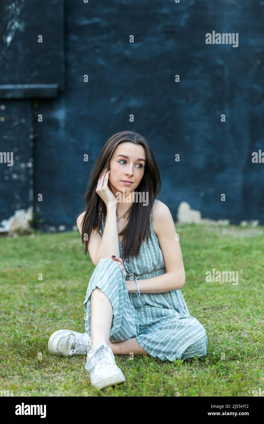 A beautiful teen brunette girl with a serious look and looking away Stock Photo