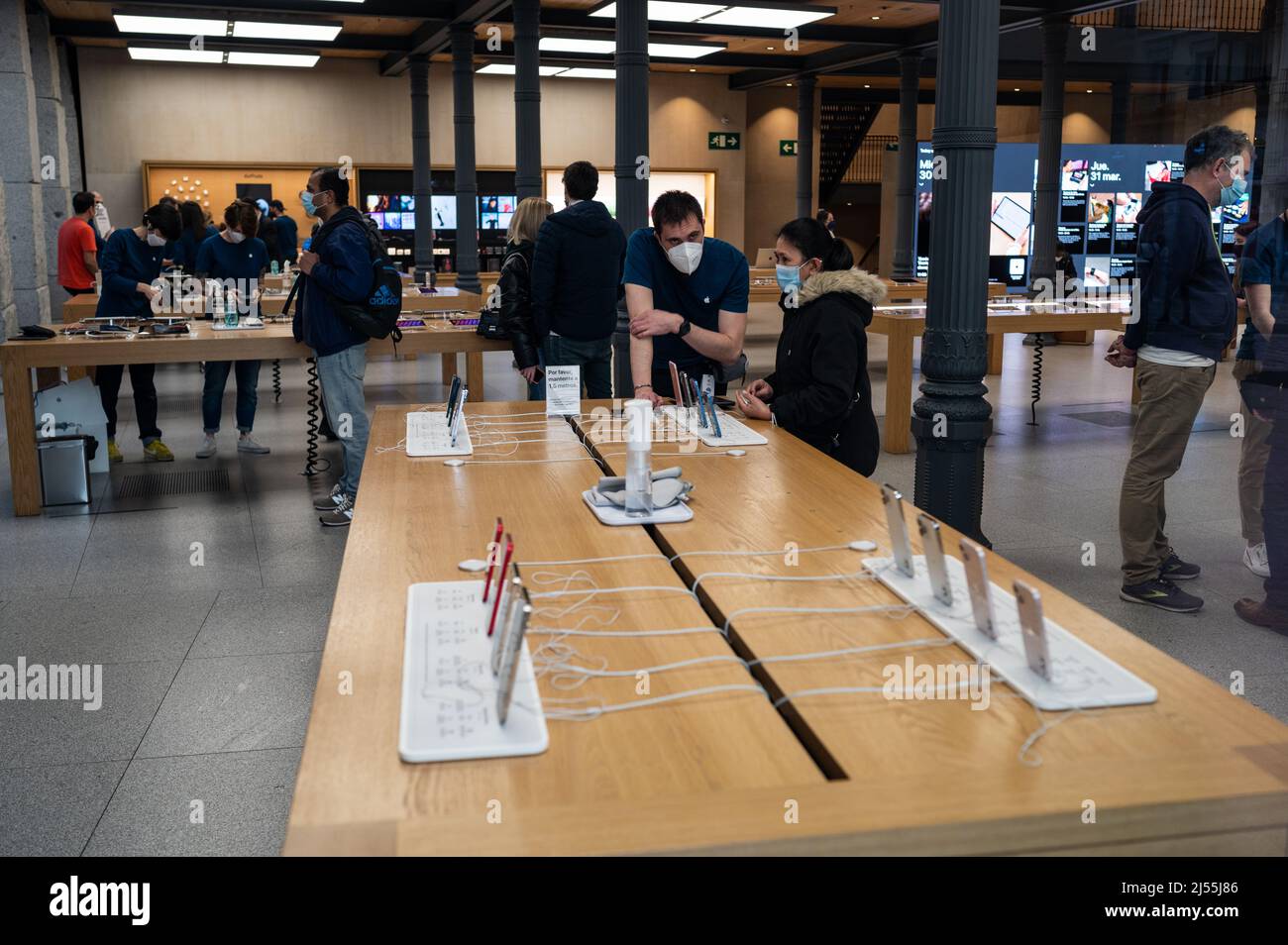 Interior view of Apple Store in Madrid Puerta del Sol with people inside Stock Photo