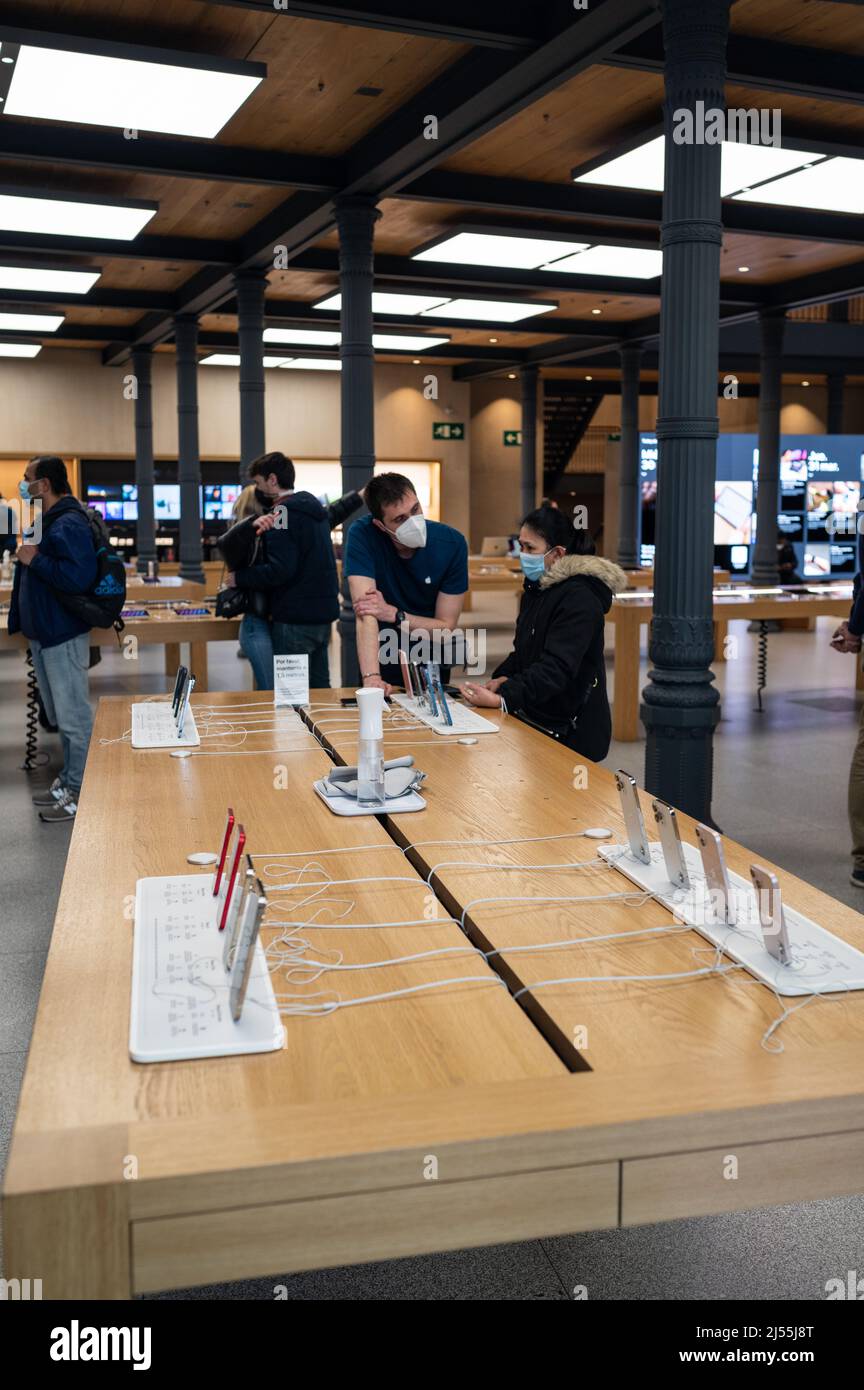 Interior view of Apple Store in Madrid Puerta del Sol with people inside Stock Photo