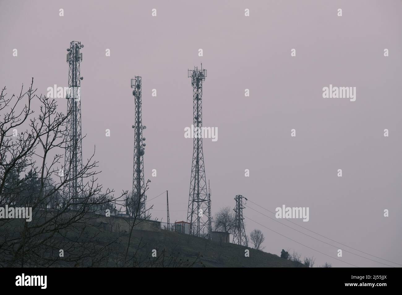 Electricity posts at winter.  radio station and wireless tower Stock Photo