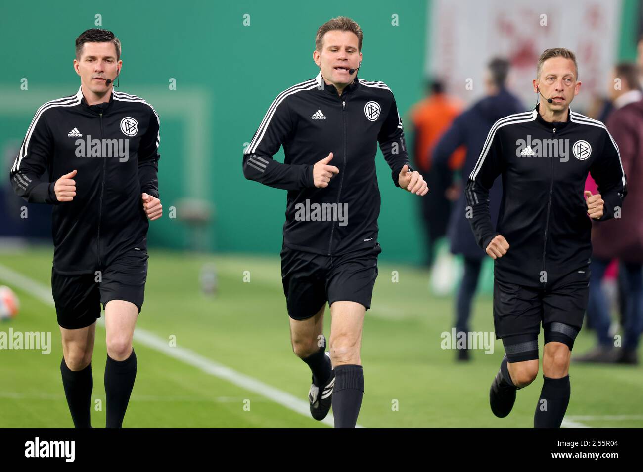 Leipzig, Germany. 20th Apr, 2022. Soccer: DFB Cup, RB Leipzig - 1. FC Union Berlin, semifinal, Red Bull Arena. Referee Felix Brych (M) warms up with his assistants Stefan Lupp (l) and Mark Borsch (r) before the game. IMPORTANT NOTE: In accordance with the regulations of the DFL Deutsche Fußball Liga and the DFB Deutscher Fußball-Bund, it is prohibited to use or have used photographs taken in the stadium and/or of the match in the form of sequence pictures and/or video-like photo series. Credit: Jan Woitas/dpa/Alamy Live News Stock Photo