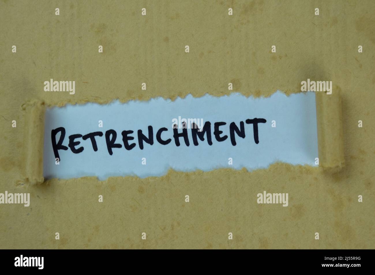Retrenchment Text written in torn paper Stock Photo