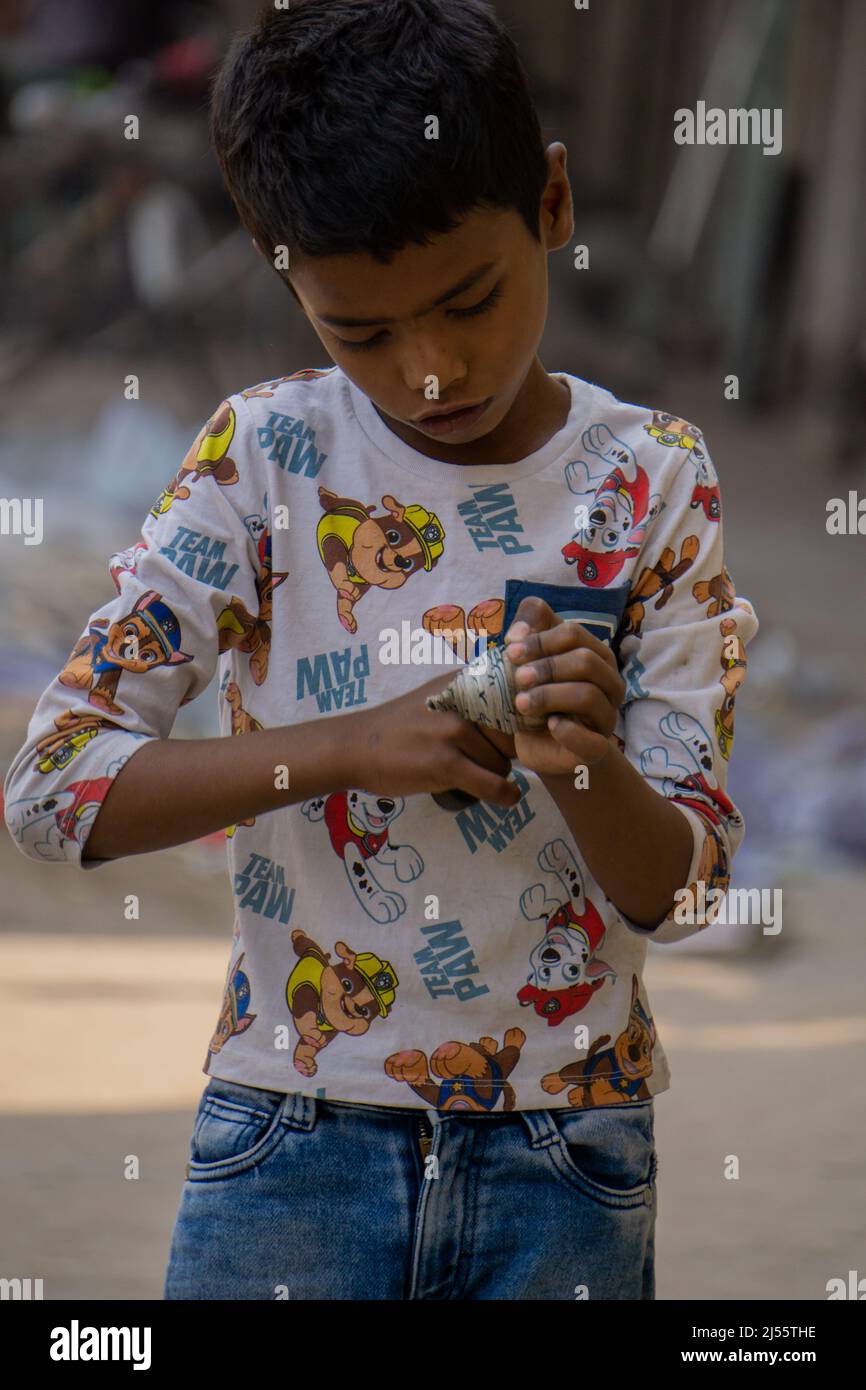 Dhaka City, Bangladesh 3-21-2022. Bangladeshi Urban Child. A child is making a latim to turn. Pictures of Dhaka city. Stock Photo