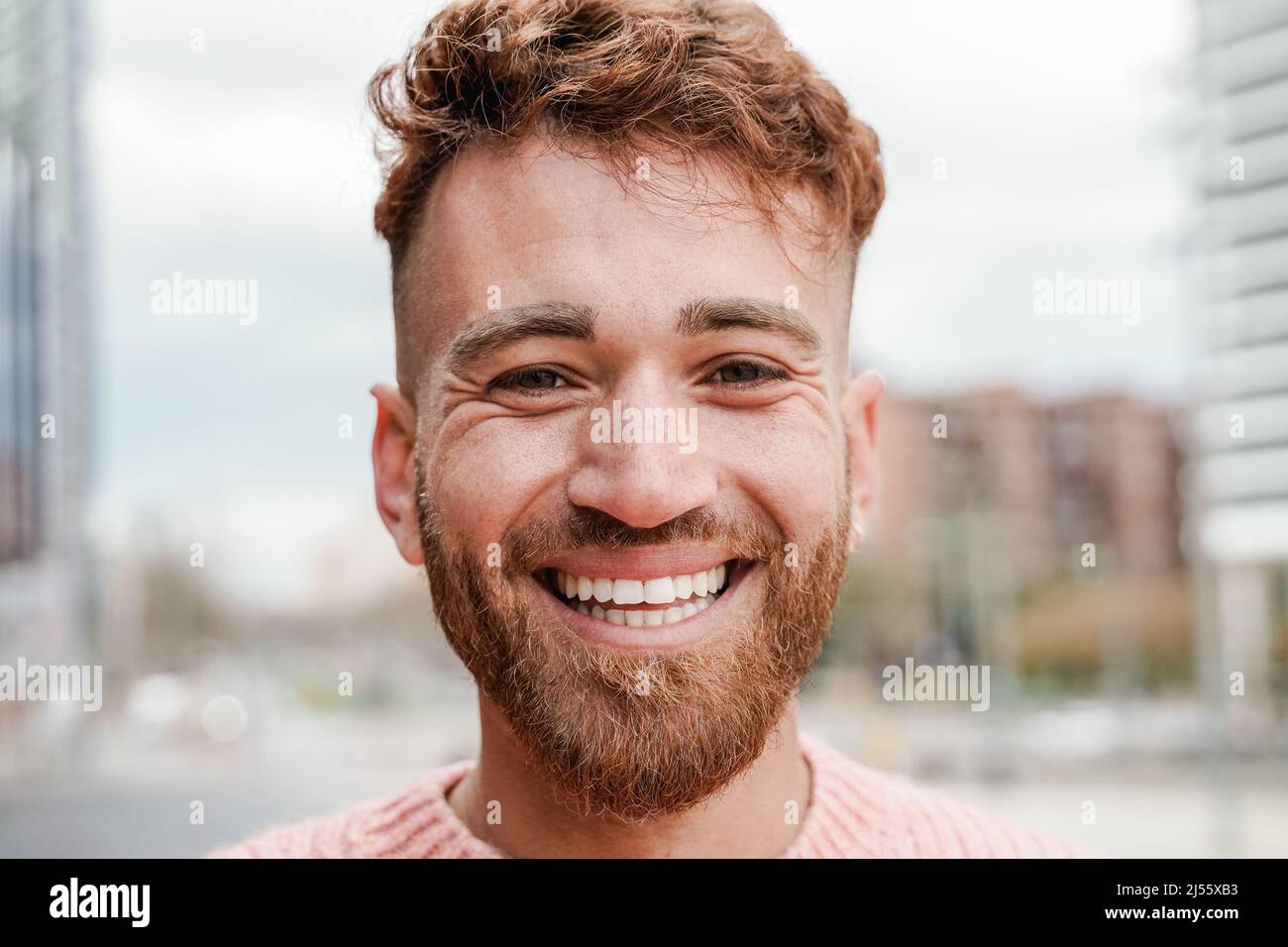 Happy ginger hair man smiling on camera outdoor - Redhead authentic people concept Stock Photo