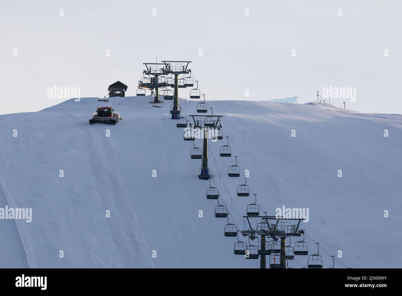 Snow groomer on the ski slope in Dolomites, Italy Stock Photo